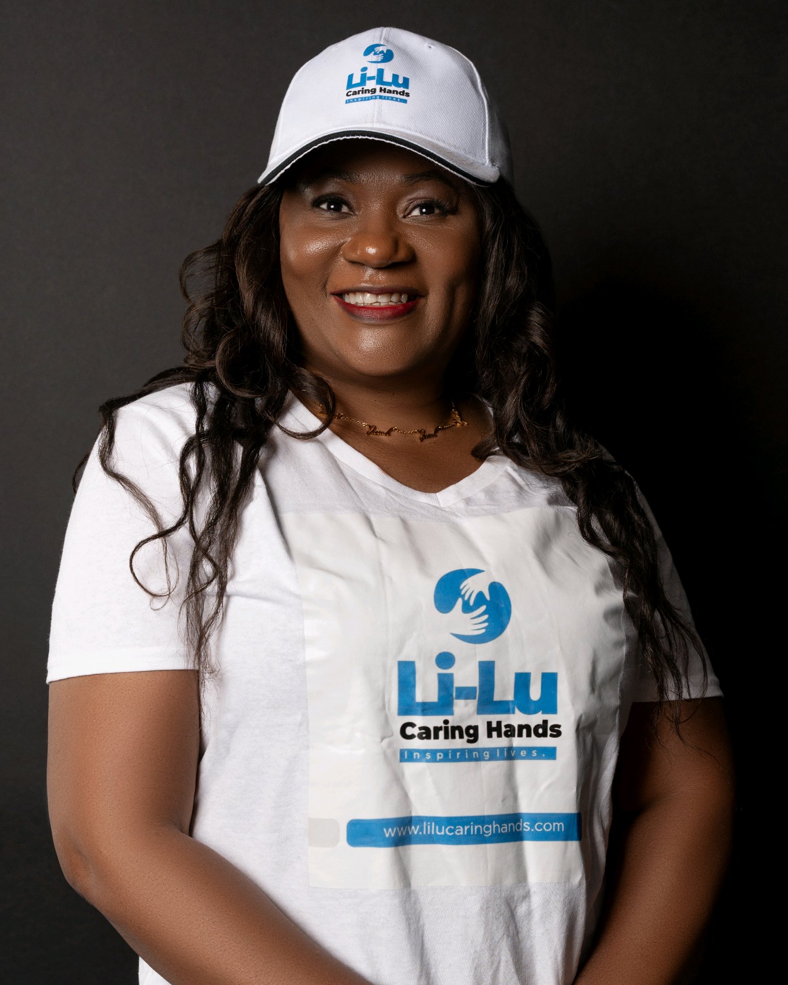 Lilian Oyama in Li-Lu Caring Hands branded outfit